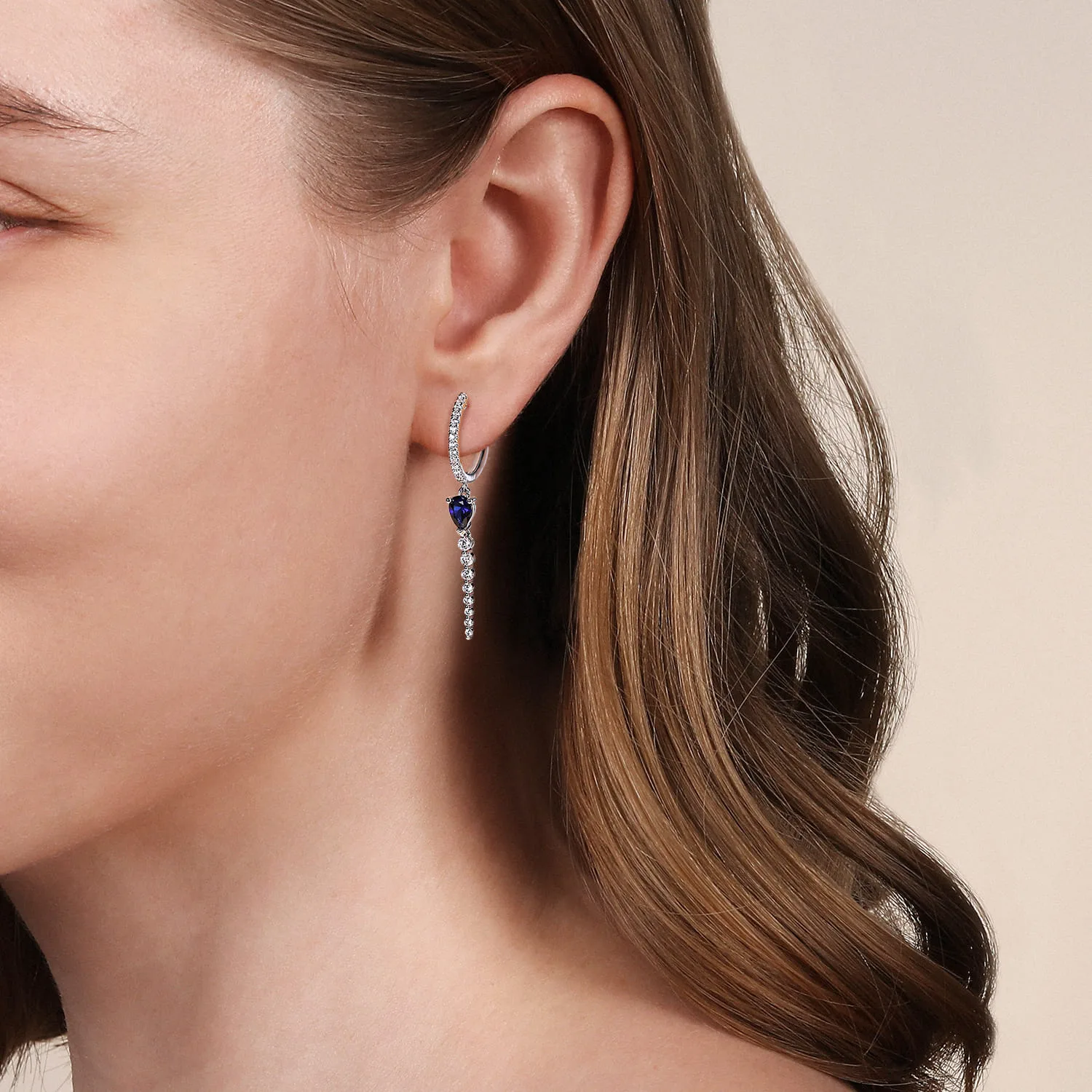 Graduating Diamonds and Blue Sapphire Huggie Drop Earrings in 14K White Gold, photograph 2